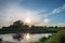 Circular halo with sundogs over a small lake