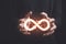 Circular infinity symbol in businessman's hand on dark background