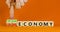 Circular or linear economy symbol. Concept words Circular economy or Linear economy on blocks. Beautiful orange background.