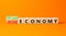 Circular or linear economy symbol. Concept words Circular economy or Linear economy on blocks. Beautiful orange table orange