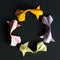 Circular round figure of handmade paper craft origami gold koi carp fishes on black background.Pattern size 1*1, view top