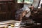 Circular saw of carpenter on table with measure tape and wooden chips at wood factory workplace