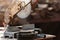 Circular saw of carpenter on table with measure tape and wooden chips at wood factory workplace