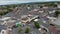 Circular shot of town centre. Square with roundabout and parked cars. Shopping streets around. Ennis, Ireland