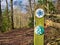 Circular signs on a weathered wooden post mark the way of a bridle path with walkers welcome.