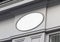 Circular storefront on a grey shop frontage Mockup. Empty store brand signboard frame in street