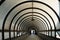 Circular tunnel with pedestrians walking out. Inside of corridor for crossing