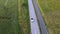 Circulating above a moving silver colored sports car on the countryside