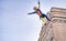 Circus clown acrobat swinging on a long pole