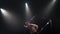 Circus male muscular performer making tricks with juggling cube props at black background. Concept of concentration