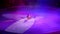 A circus performer in a bright costume performs in the circus arena with juggling sticks, creates a show for the