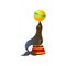 Circus seal playing with yellow ball on red round stand