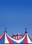 Circus tent under blue sky colorful stripes