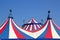 Circus tent under blue sky colorful stripes