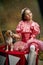 Circus trainer. Portrait of little cute beautiful girl in festive dress training funny doggy at vintage circus. Holidays