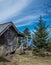 Cirrus Clouds Above Weathered Cabin