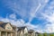 Cirrus clouds against the vivid blue sky over the residential houses at Daybreak, Utah
