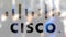 Cisco Systems logo on a glass against blurred crowd on the steet. Editorial 3D rendering