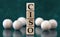 CISO - acronym on wooden cubes on a green background with wooden balls