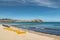 Citadel of Calvi with sunbeds lined up on beach in Corsica