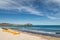 Citadel of Calvi with sunbeds lined up on beach in Corsica