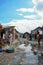 Cite Soleil, Haiti - March, 2017: Women and children walk in the mud through CitÃ© Soleil, an extremely impoverished and densely