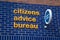 Citizens Advice Bureau sign in yellow and blue on brick wall
