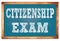 CITIZENSHIP EXAM words on blue wooden frame school blackboard