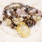 Citrine mineral stone pendant beads necklace on decorative background