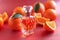 Citrus allure Red background complements perfume bottle adorned with Mandarin