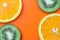 Citrus background, sliced orange and kiwi. Tropical abstract backgrounds, fruits pattern with copy space for text. Flat lay with