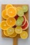 Citrus composition on chopping board. Many halved lemons, limes, grapefruits. Vertical