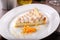 Citrus cream cheesecake piece with orange zest close-up