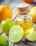 Citrus essential oil and slice of orange, lemon and lime fruits