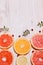 Citrus fruit cut in half - oranges, lemons, tangerines, grapefruit on a wooden background