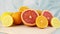 Citrus fruits on blue background - Grape fruit, lemons and oranges on cutting board