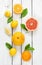 Citrus fruits (lemon, grapefruit and orange) on white wood