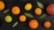 Citrus fruits: lemon, grayfruit, mandarin, orange, lime on a dark gray wooden background. Top view. 4k video.Camera movement from