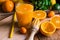 Citrus fruits oranges lemons lime cumquat, fresh mint, reamer, freshly pressed juice in glass