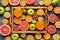 Citrus fruits sliced harvest mix flat lay in wooden tray on blue concrete background, healthy vegetarian organic food