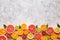 Citrus fruits vegan mix flat lay on white background, helthy vegetarian organic food