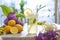 Citrus iced lemonade in pitcher and lemons glasses with lemon slice decoration and on marble table with lilac flowers