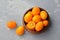 Citrus kumquat fruits in wooden bowl. Healthy vegan food. Kumquat fruit cut in half. Top view