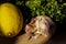 Citrus lemon, garlic and parsley fresh and healthy food products laying on wooden chop board ready to cook - food image close up w