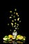 Citrus lemonade with lemon, lime and ice in a glass on a black background. Splash. Levitation.