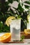 Citrus mint lemonade with ice cubes in glass Cup next to vintage carafe. Summer drink Limoncello