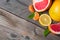 Citrus set of grapefruits, lemons and tangerines on old wooden background.