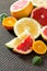 Citrus set of grapefruits and tangerines on a concrete gray background