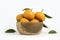 Citrus sinensis  called jeruk baby santang  with leaves â€“ local fresh fruit from Indonesia. Isolated fruit on a wooden basket