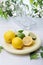 Citrus squeezer and fresh lemons being used to make lemonade